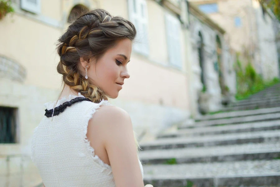 Woman with brown hair wearing Dutch braids on the side