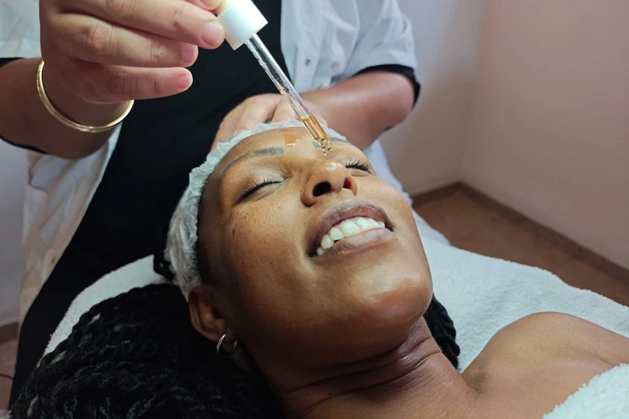 Woman with dark skin getting tretinoin treatment on face