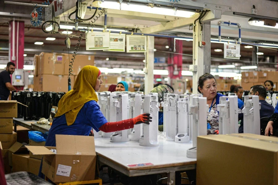 Women and men working in a factory