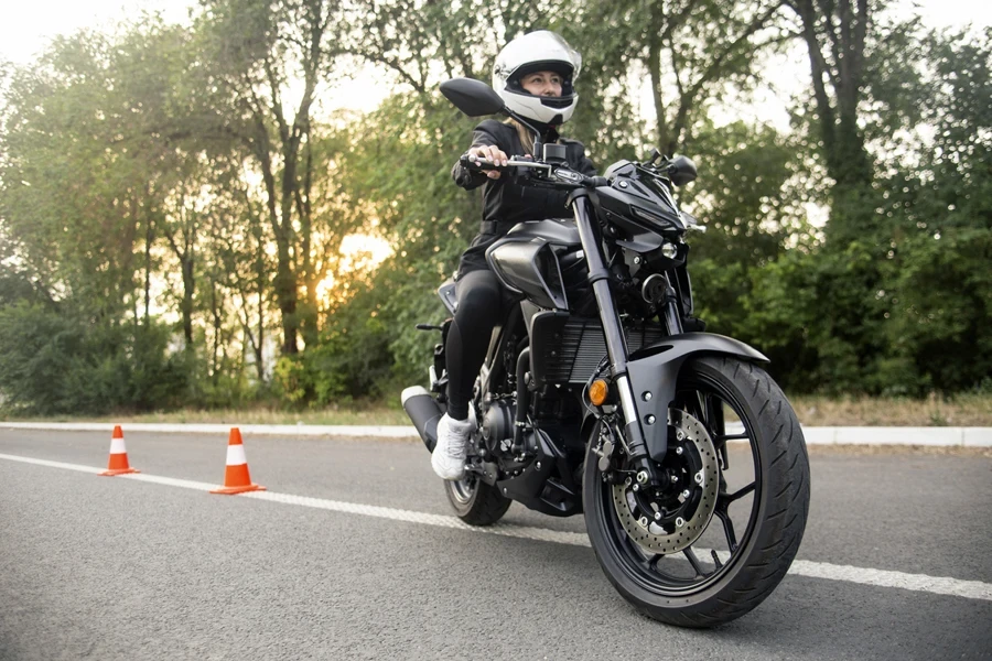 Young woman learning to ride a motorcycle