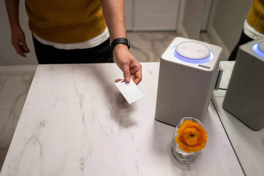 A Person Standing Beside a Table Holding a White Card