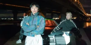 A Woman in Blue Jacket Standing Near a Woman in Black Jacket