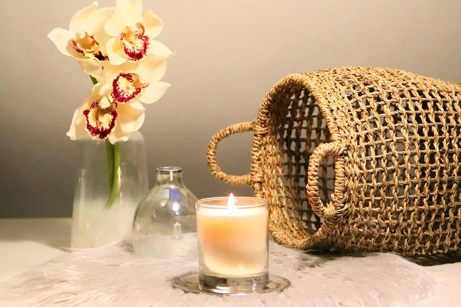 A candle burning near glass jars