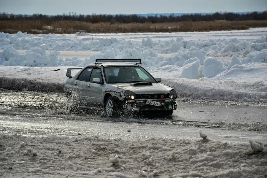 A car driving through a puddle of snow