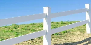 A close-up of a white fence in a field