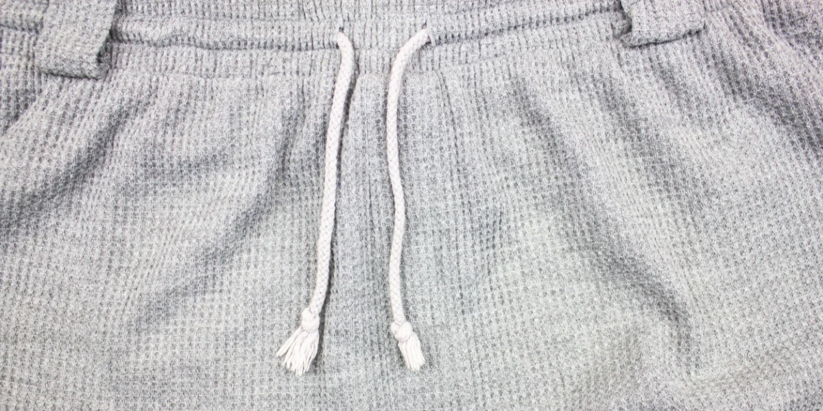 A closeup of a grey waffle-knit jogger