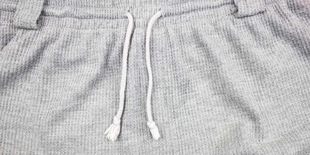 A closeup of a grey waffle-knit jogger