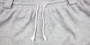 A closeup of a grey waffle-knit jogger