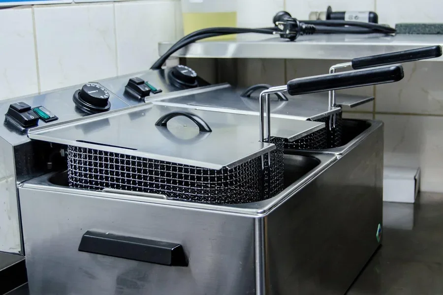 A deep fryer with a grid and a black handle