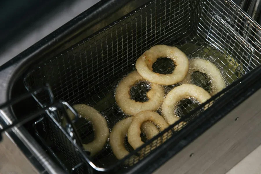 A frying onion rings in a deep fryer