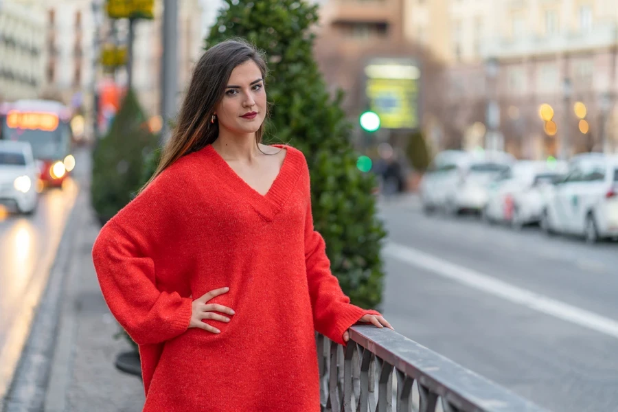 A good-looking woman in a red V-neck sweater dress