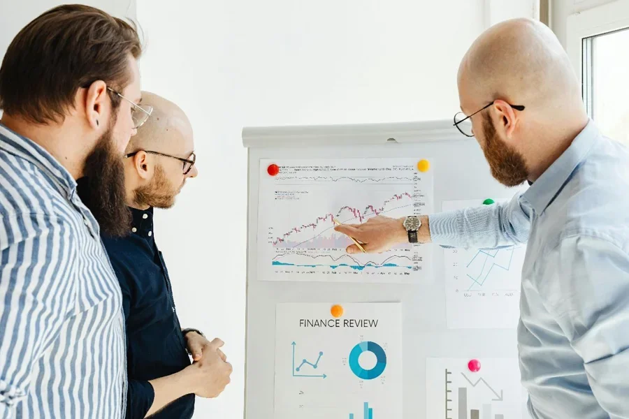 A group of men looking at a white board