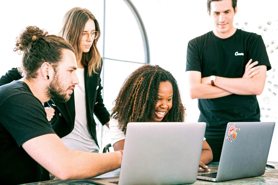 A group of people looking at laptops