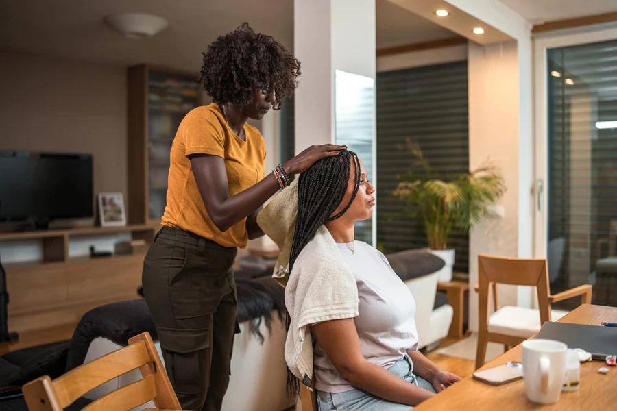 A hair stylist working on a client’s hair