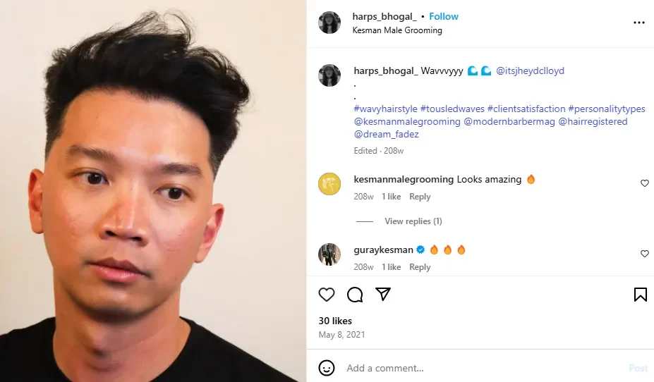 A man posing with medium-length tousled waves