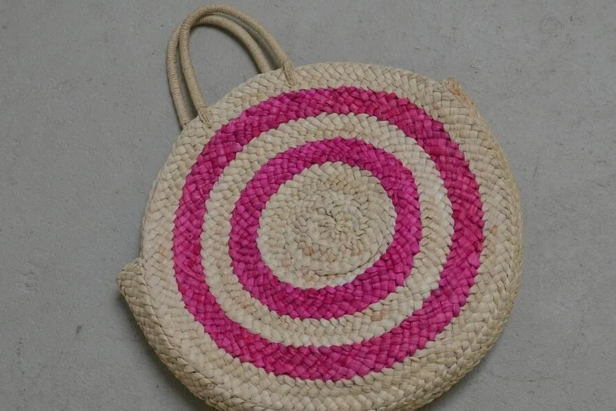 A multi-colored backpack on the floor