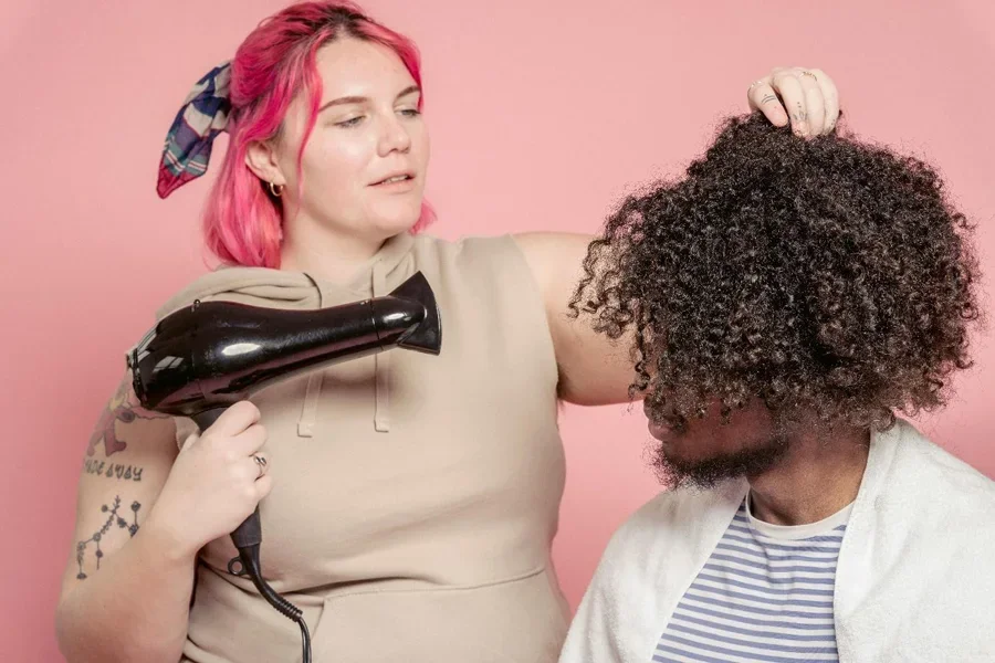A person blow drying a person's hair