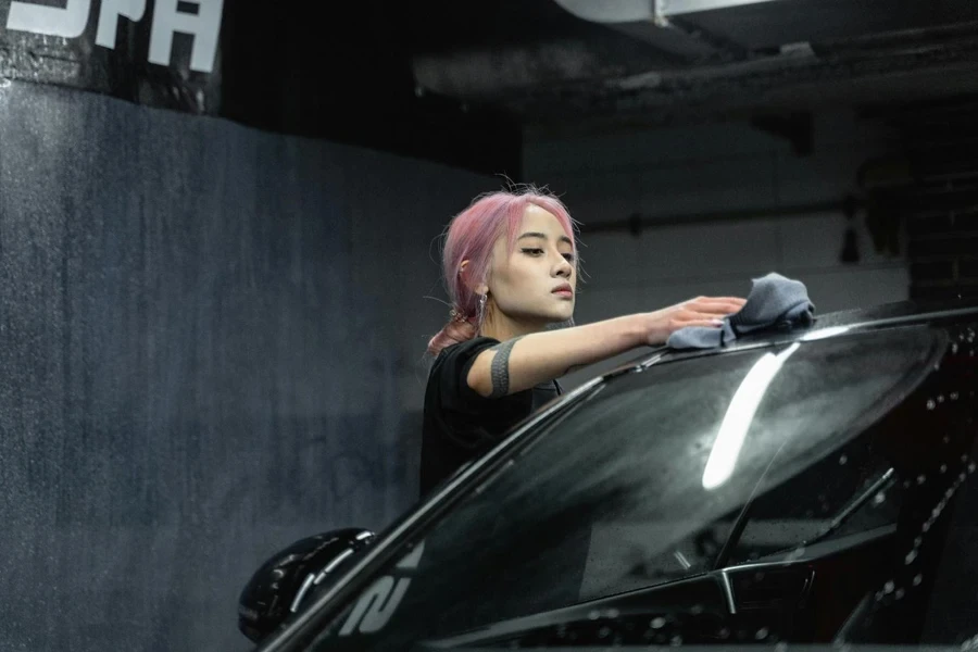 A person cleaning a car