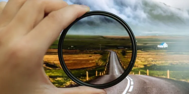 A person holding camera lens