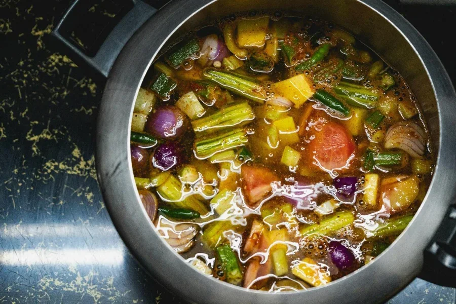 A pot of soup with vegetables