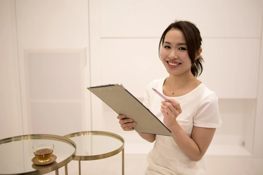 A therapist holding a writing board and pen
