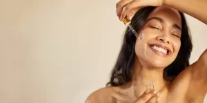 A woman applying glycolic acid serum on her face
