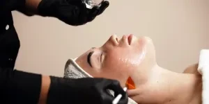 A woman getting a cosmetic peeling mask application
