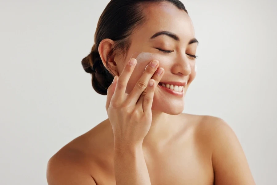 A woman happily using makeup product