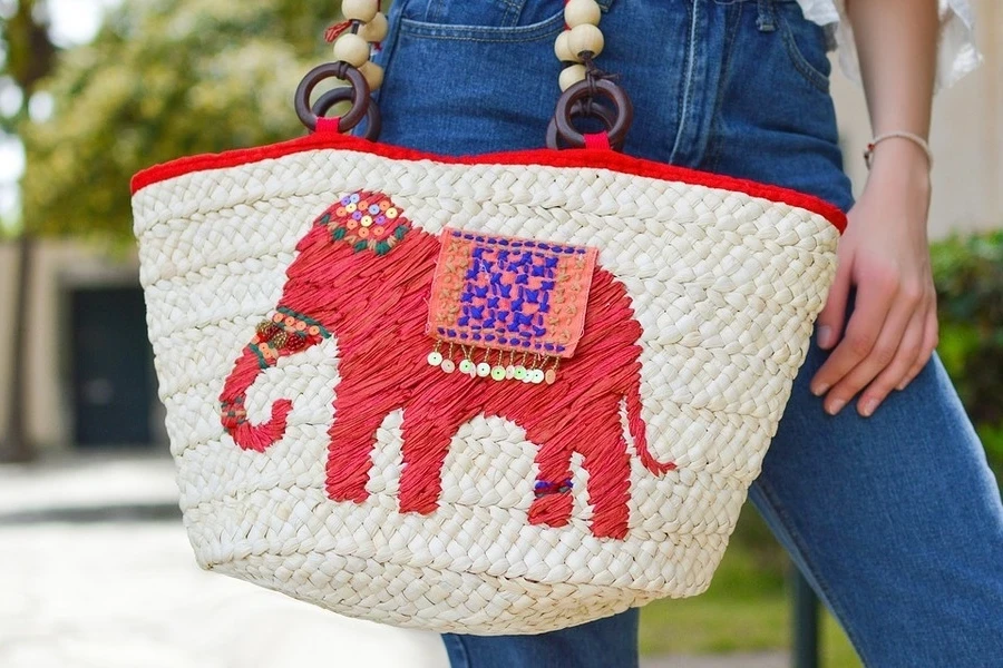 A woman in jeans carrying a basket bag
