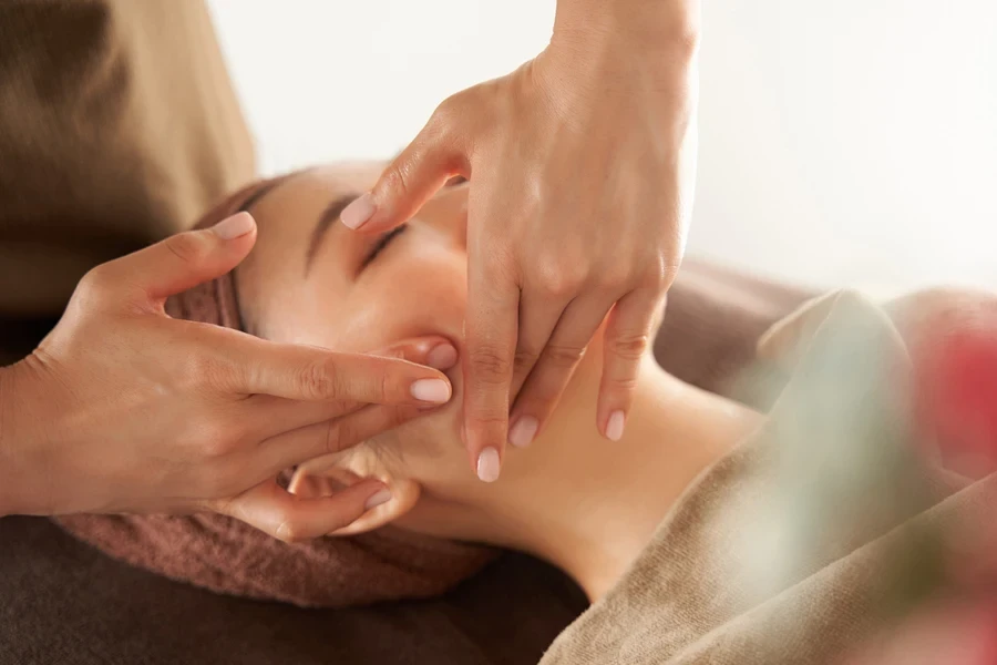 A woman receiving a facial massage