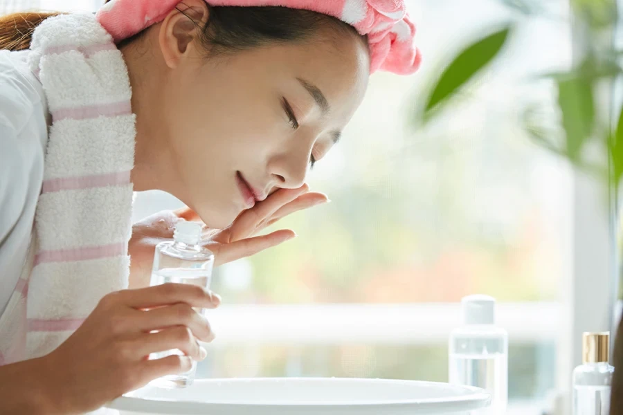 A woman using a facial cleanser