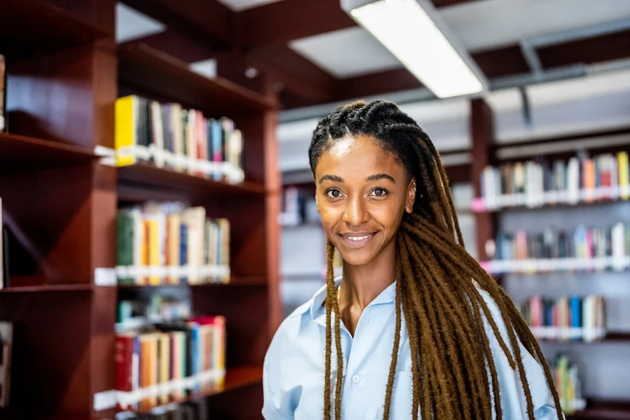 A women with locs in a library