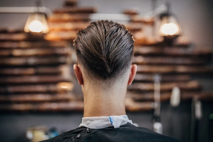 Back of man’s head showing mid drop fade cut
