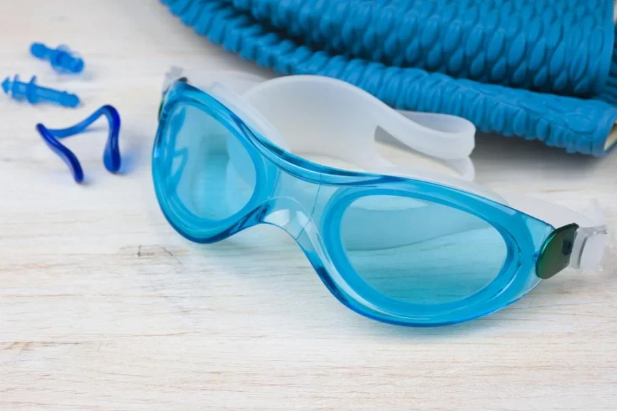 Blue swimming equipment on wooden background