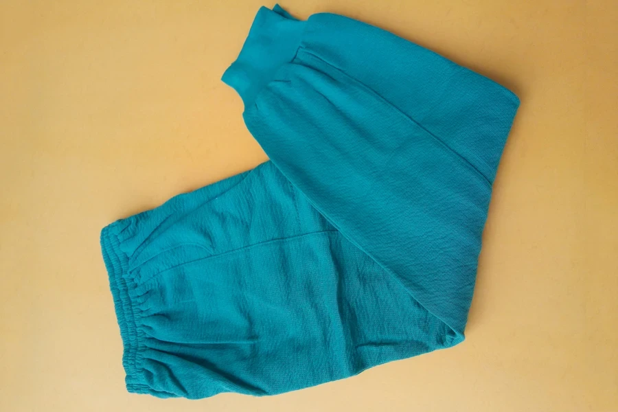 Blue waffle-knit joggers on a brown background