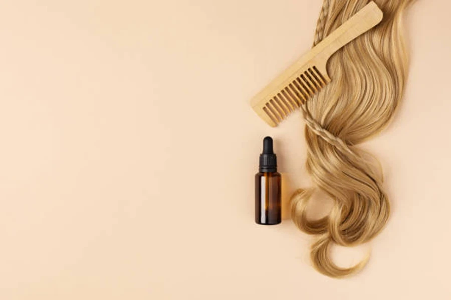 Bottle of oil for restore and recovery of damaged hair. Hair curl and hair oil top view.