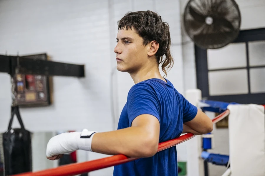 Boy in boxing ring with modern style mullet