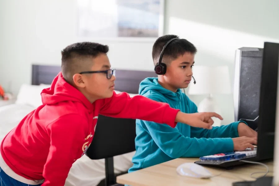 Children playing videogames with a portable gaming monitor
