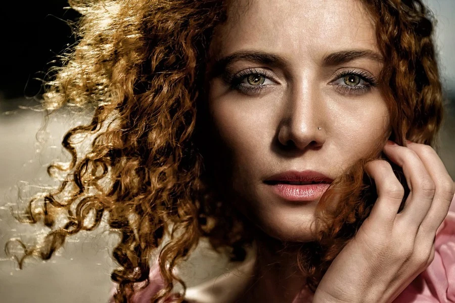 Close-up of a woman with curly hair