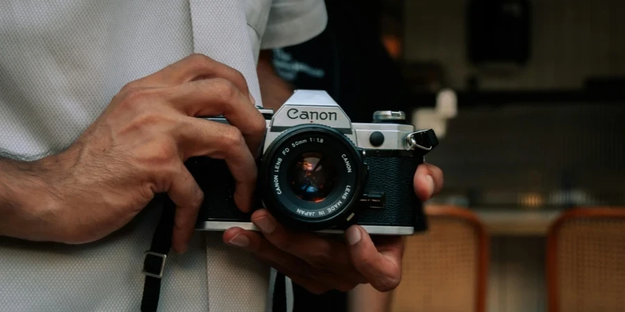 Close-up of hands holding vintage film camera