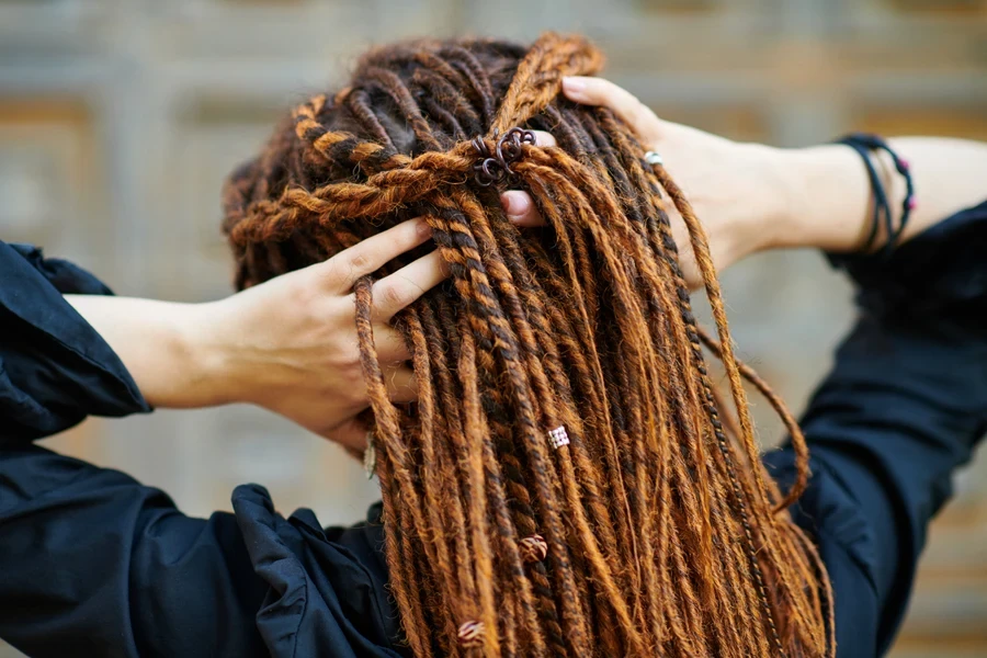 Close-up of woman with amber-colored microlocks