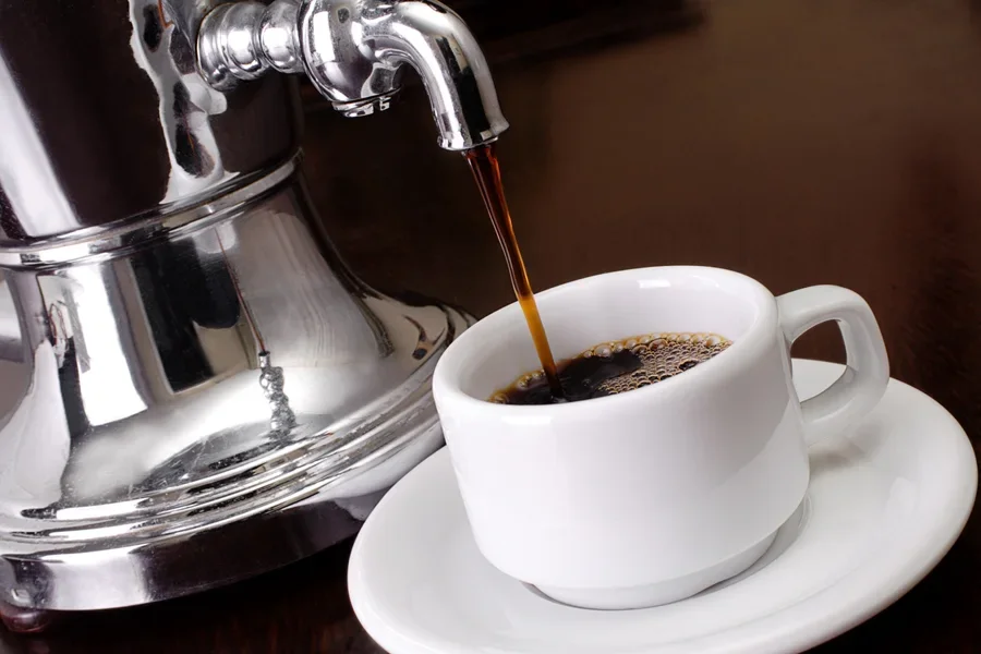 Coffee pouring in a cup from a coffee urn
