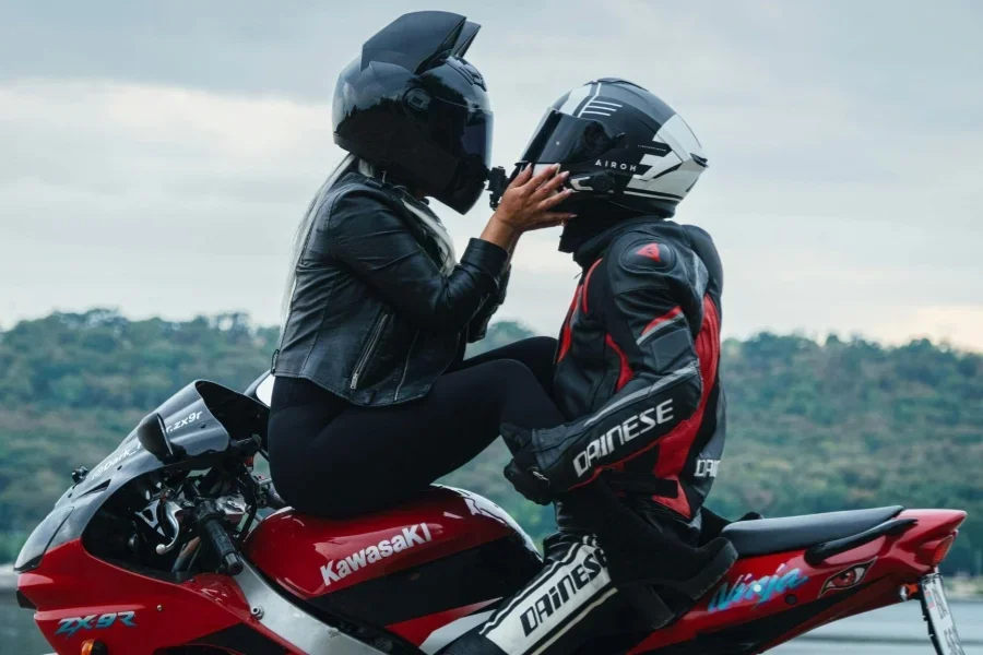 Couple on Motorcycle with Helmets Near Scenic View