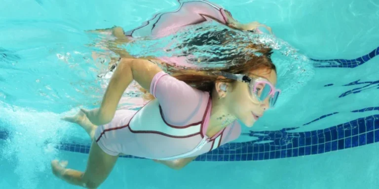 Lindo niño nadando en la piscina