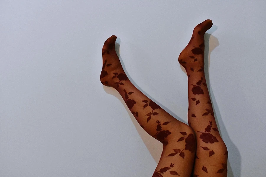 Elegant floral-patterned stockings showcased with smooth, minimal background
