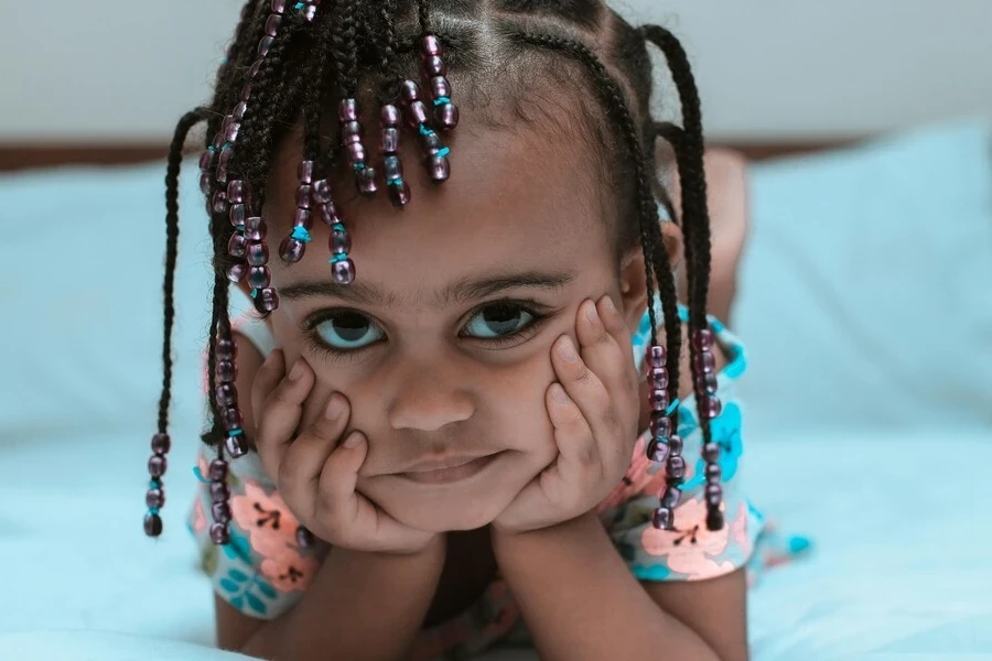 Girl with braided hair adorned with beads