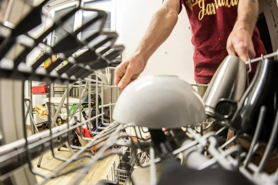 Hands of a person pulling the dishwasher rack