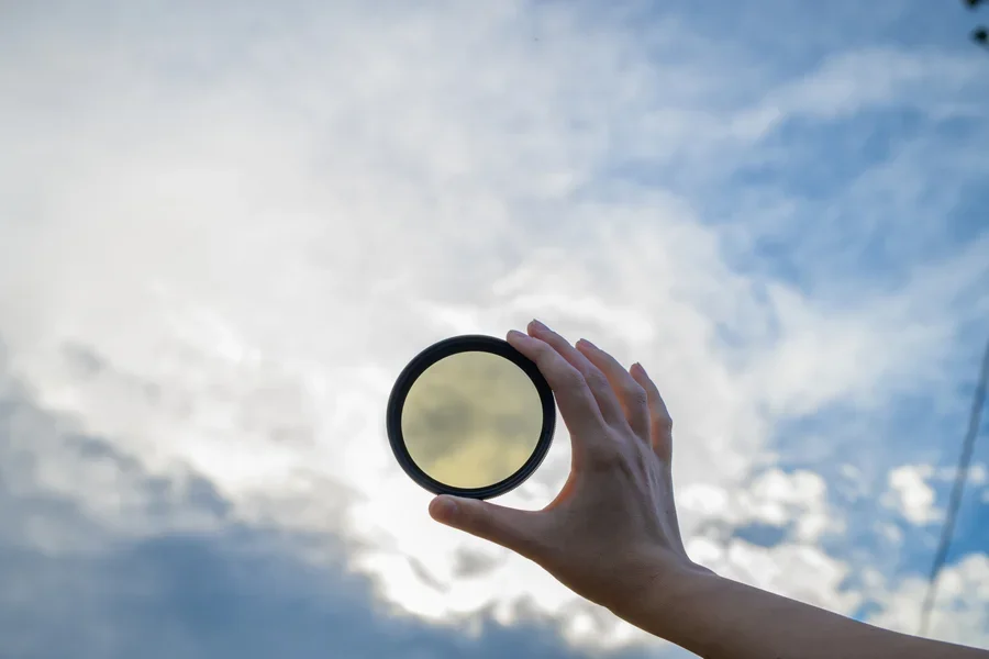 Lens filter held against the sky