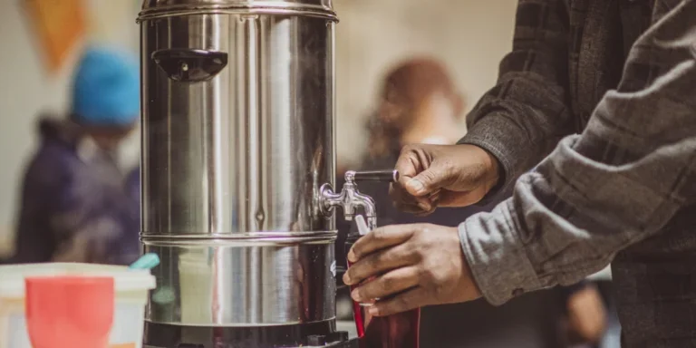 Мужчина подает кофе из кофейника