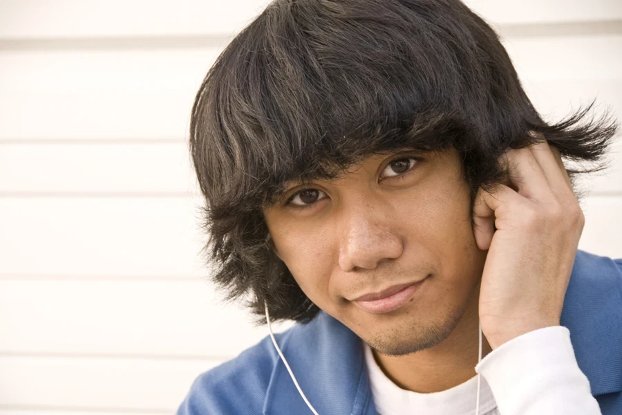 Man with headphones in and styling classic mod cut